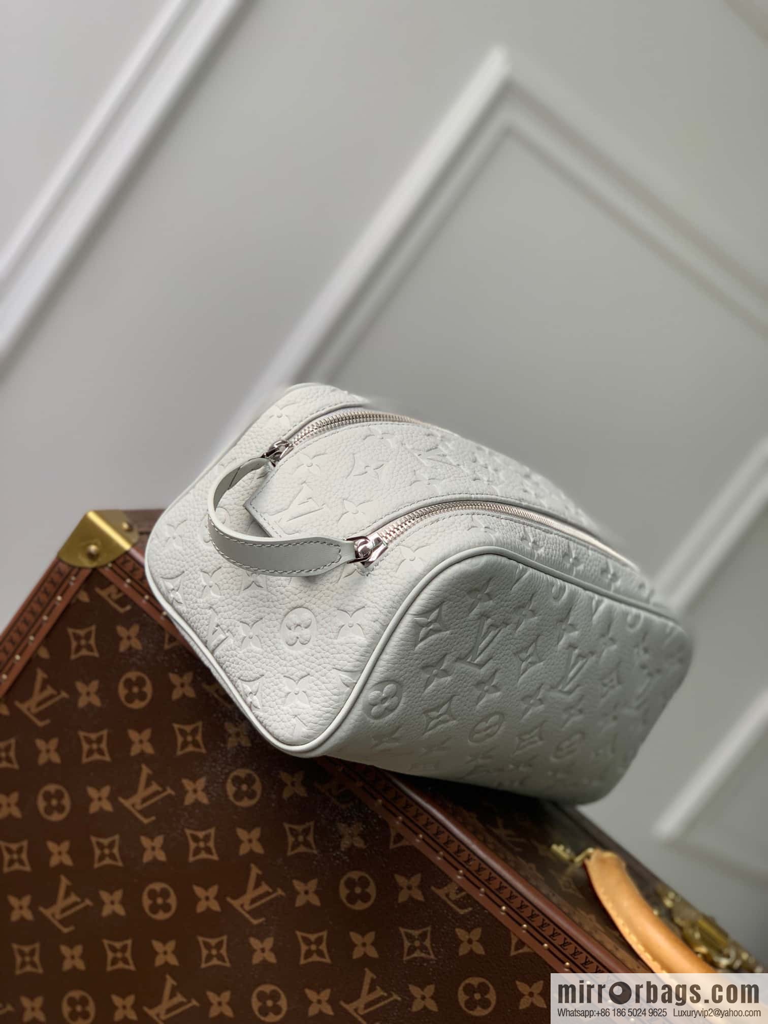 M82576 Gray and white, this Dopp Kit toilet bag.