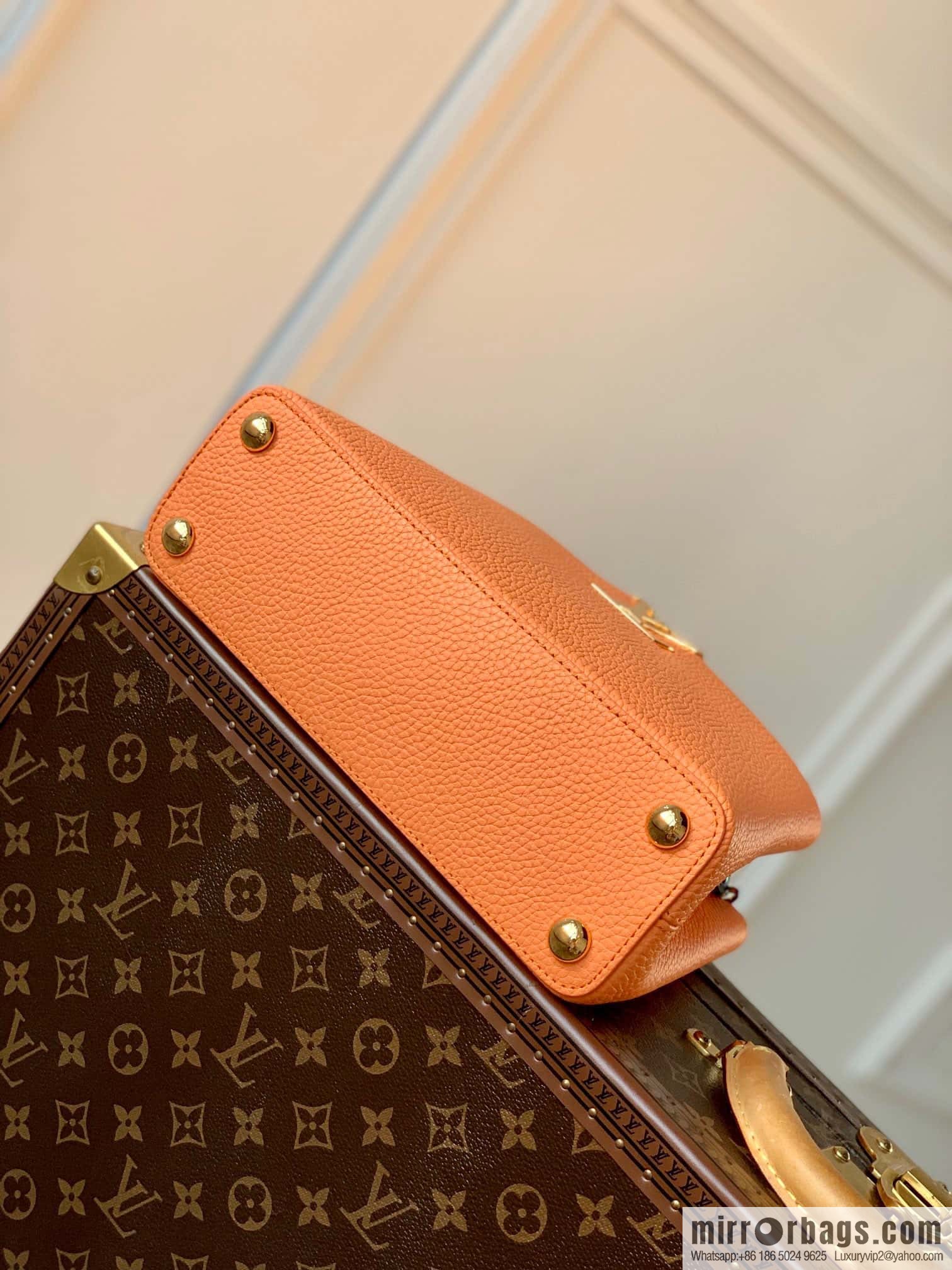 M22055 Coral Orange, Small, this Capucines Mini handbag.