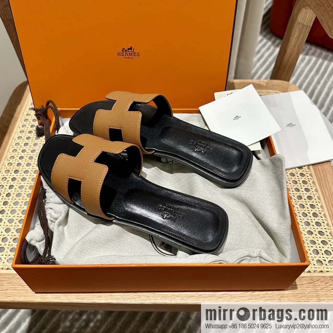 Hermès leather outsole H slippers, black and brown.