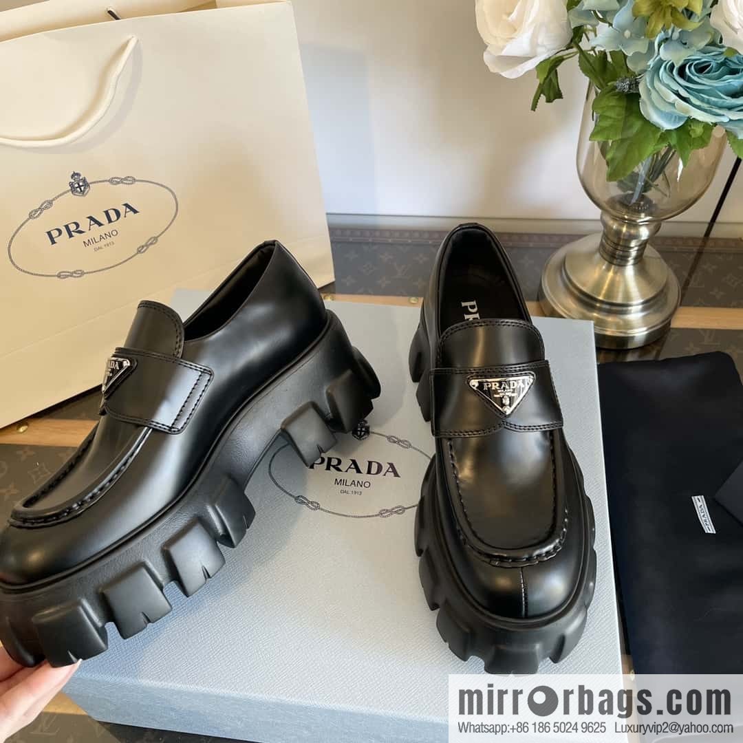 PRADA Prada, triangular label, serrated wheel muffin platform loafers 1D246M