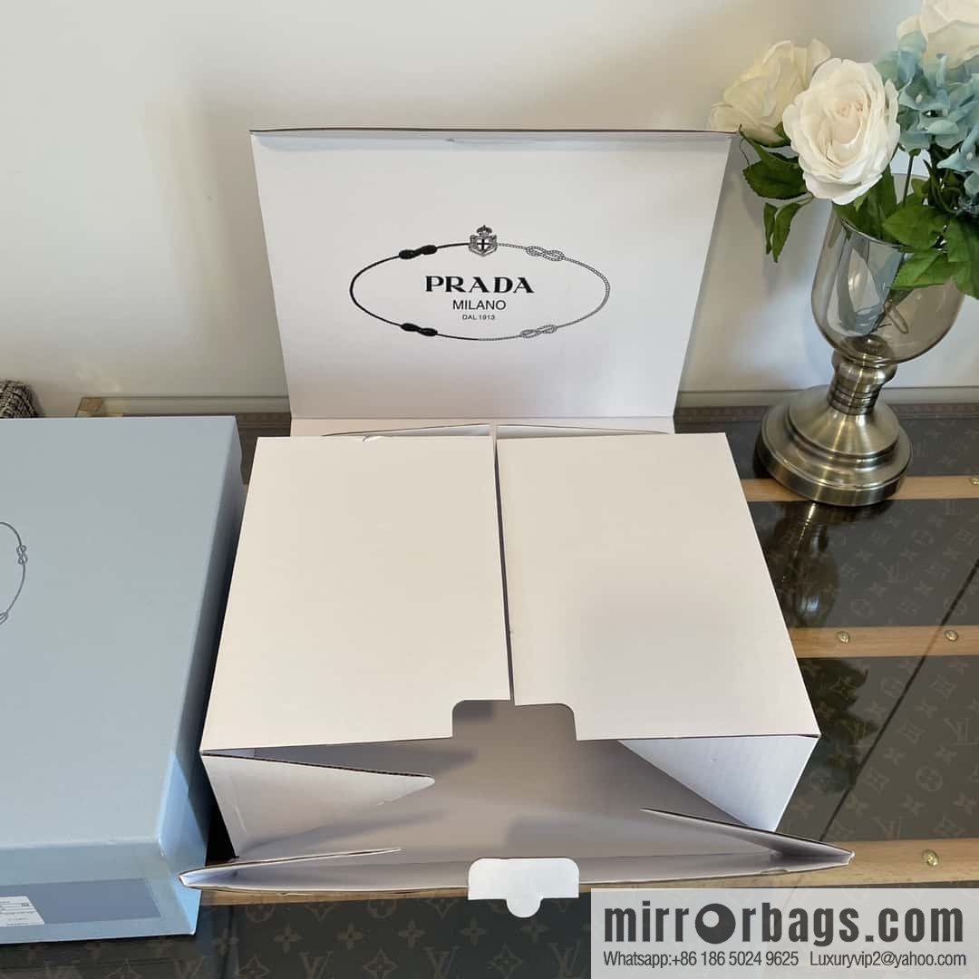 Prada, Puhada glossy patent leather triangle loafers